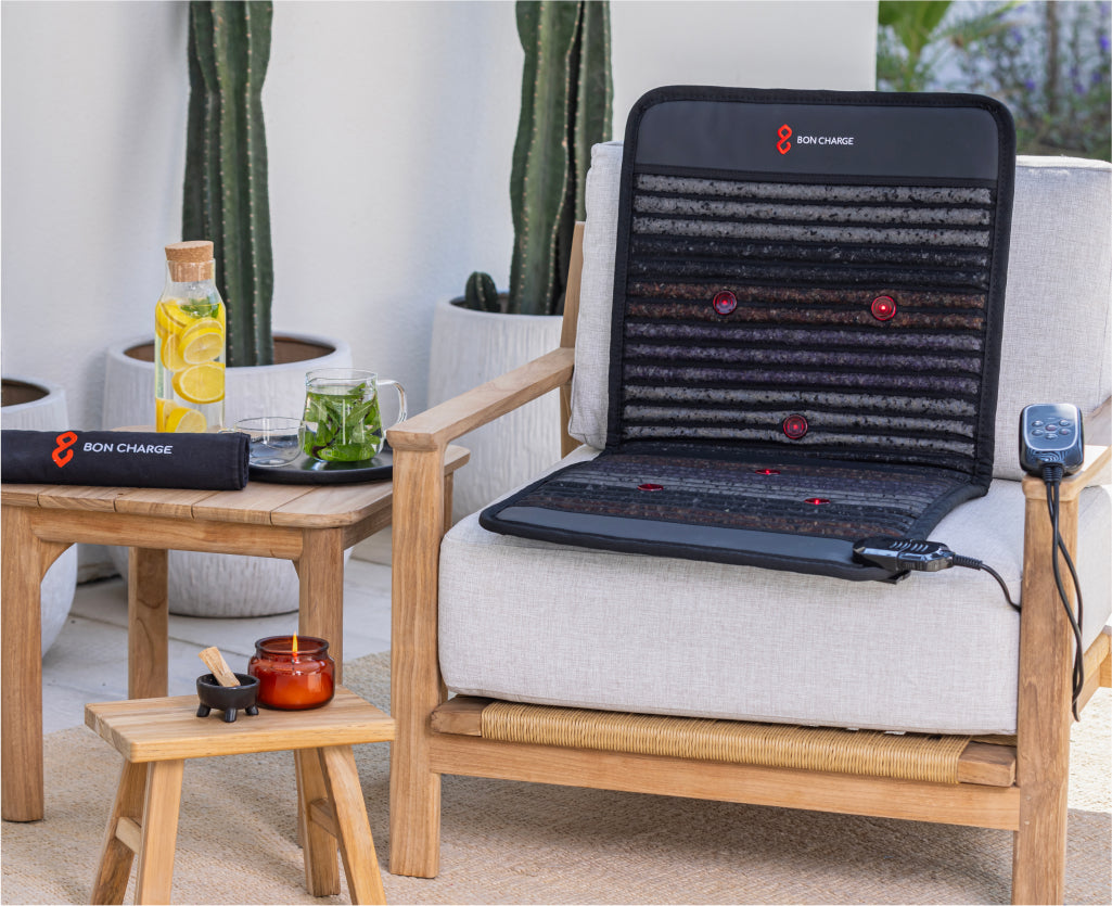 PEMF Mat Demi Placed On Chair Next To Side Table Outside